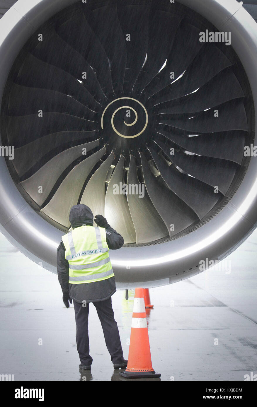 Vancouver, Canada. 28th Mar, 2017. An airport ground crew member inspects the engine of an Airbus A350-900 passenger jet after its first scheduled flight to Canada in Vancouver, Canada, on March 28, 2017. A new Airbus A350-900 passenger jet made its first scheduled flight to Canada on Tuesday and began Cathay Pacific's use of the plane for its Vancouver-Hong Kong route. Credit: Liang Sen/Xinhua/Alamy Live News Stock Photo