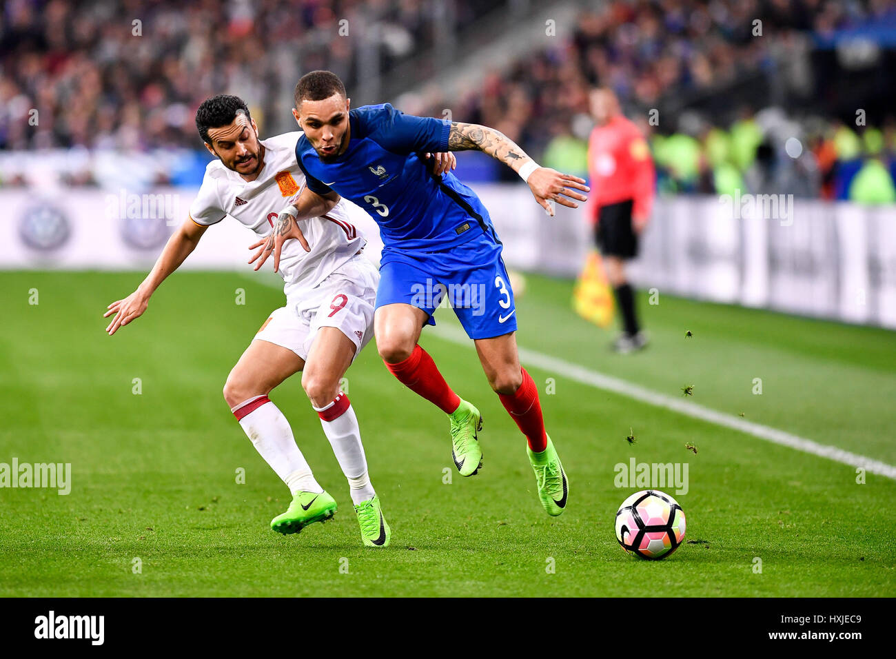 Paris, France. 29th Mar, 2017. Layvin Kurzawa (R) of France vies with Pedro Rodriguez of Spain during the friendly match between France and Spain in Paris, France, March 29, 2017. Spain won 2-0. Credit: Chen Yichen/Xinhua/Alamy Live News Stock Photo