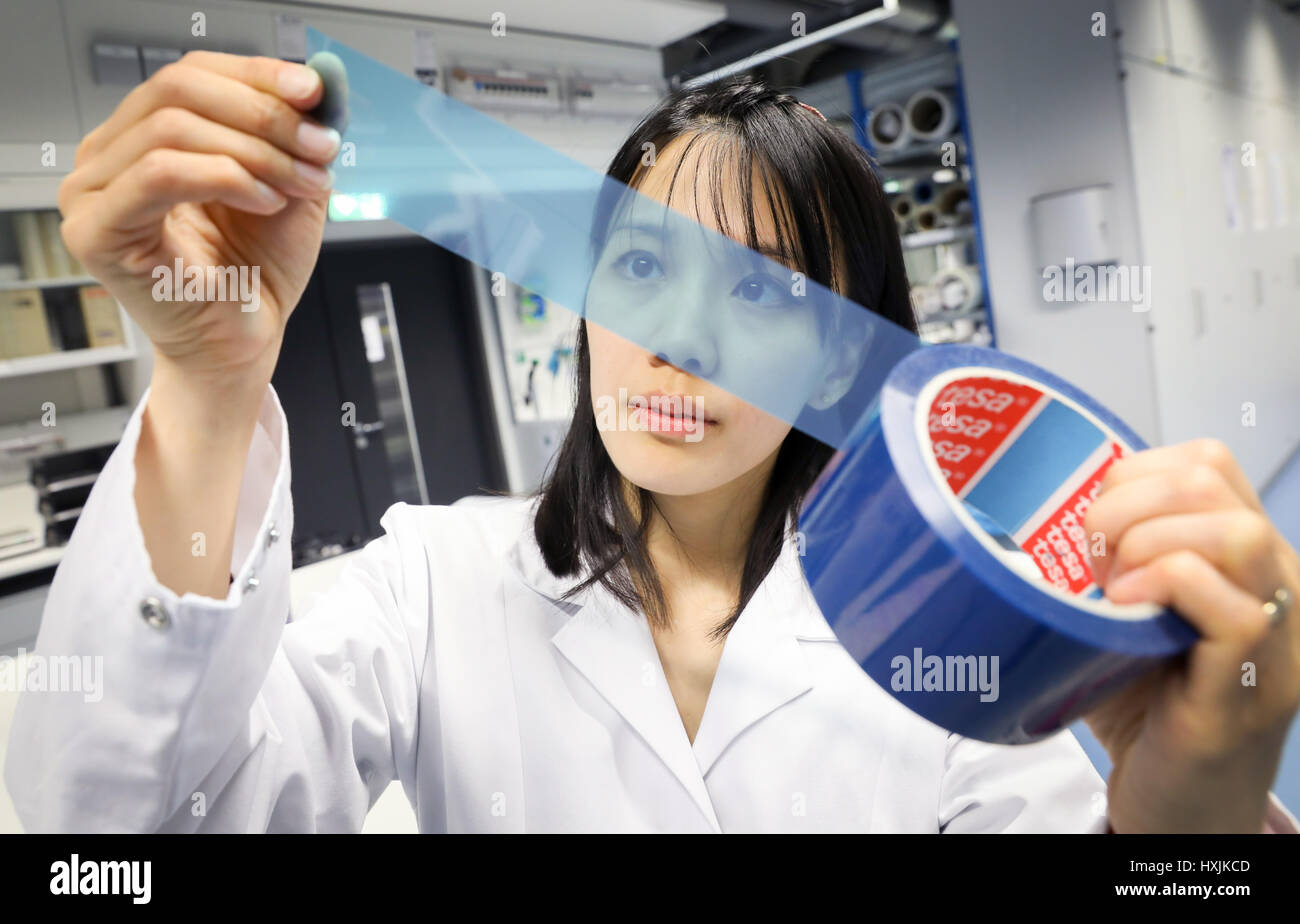 Norderstedt, Germany. 29th Mar, 2017. Lab manager Cai Rong Lim examines ...