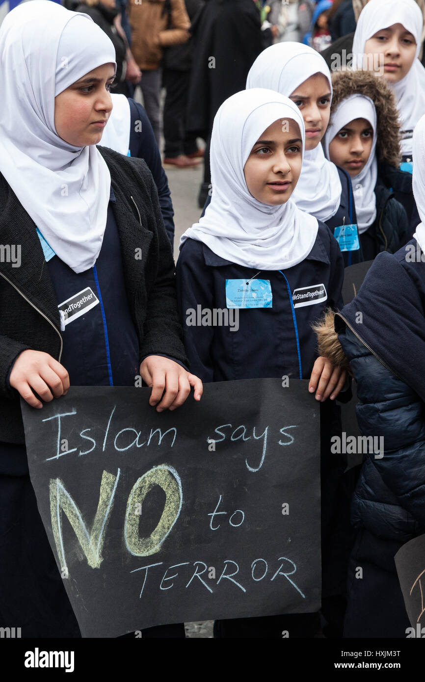 London, UK. 29th March, 2017. Young members of the Muslim community on Westminster Bridge during a tribute by the Metropolitan Police and faith leaders to the victims of last week's attack in Westminster. Credit: Mark Kerrison/Alamy Live News Stock Photo