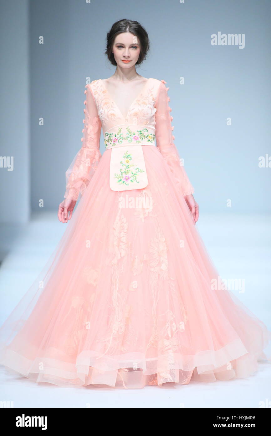 Model presents wedding dress during hi 