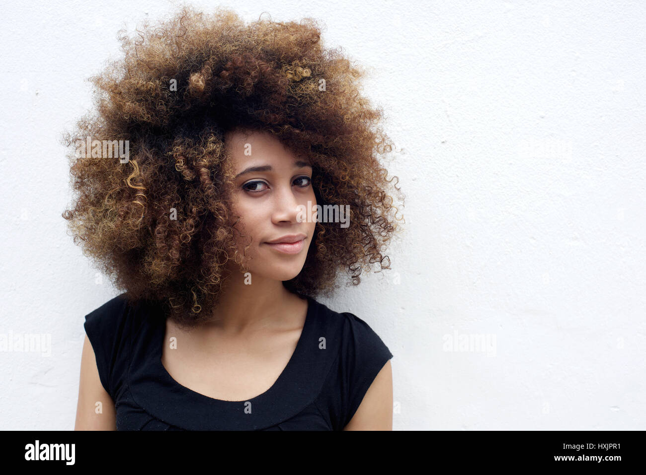 Portrait of beautiful african woman with curly hair against white ...