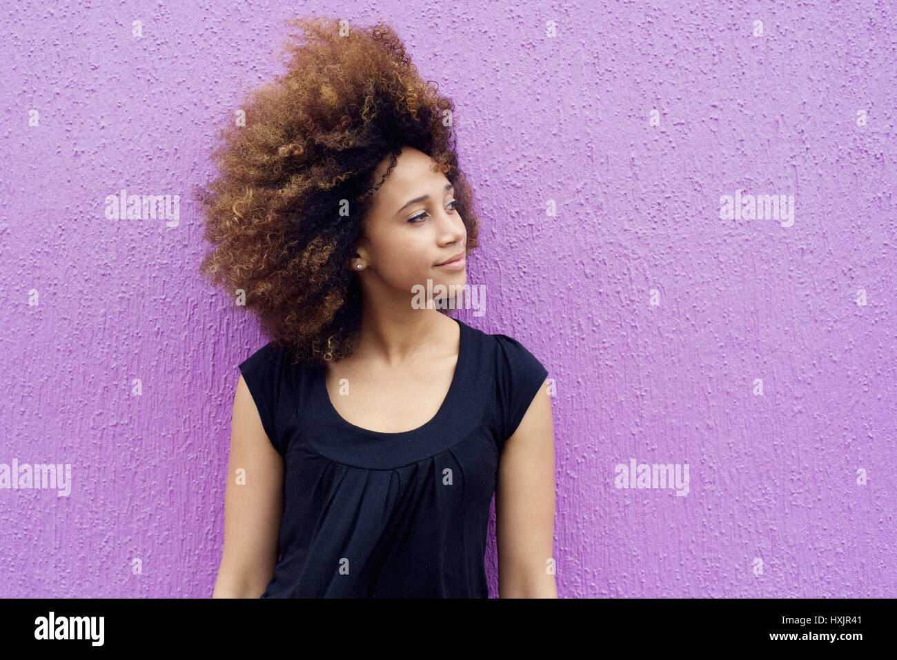 Portrait of young african woman thinking and looking away Stock Photo ...