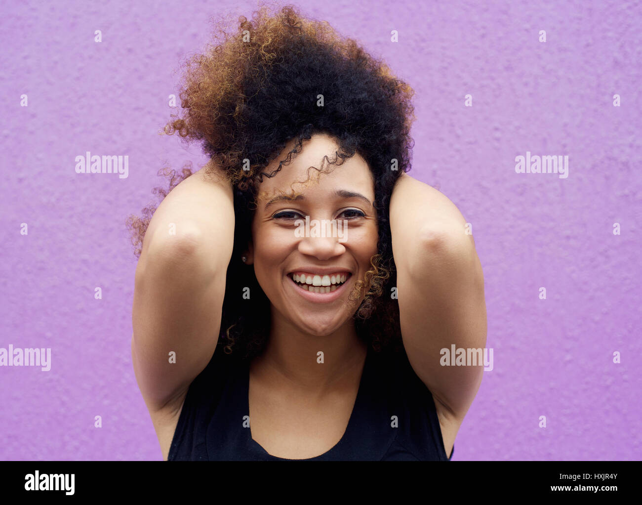 Close up african american woman smiling with hand in hair Stock Photo ...