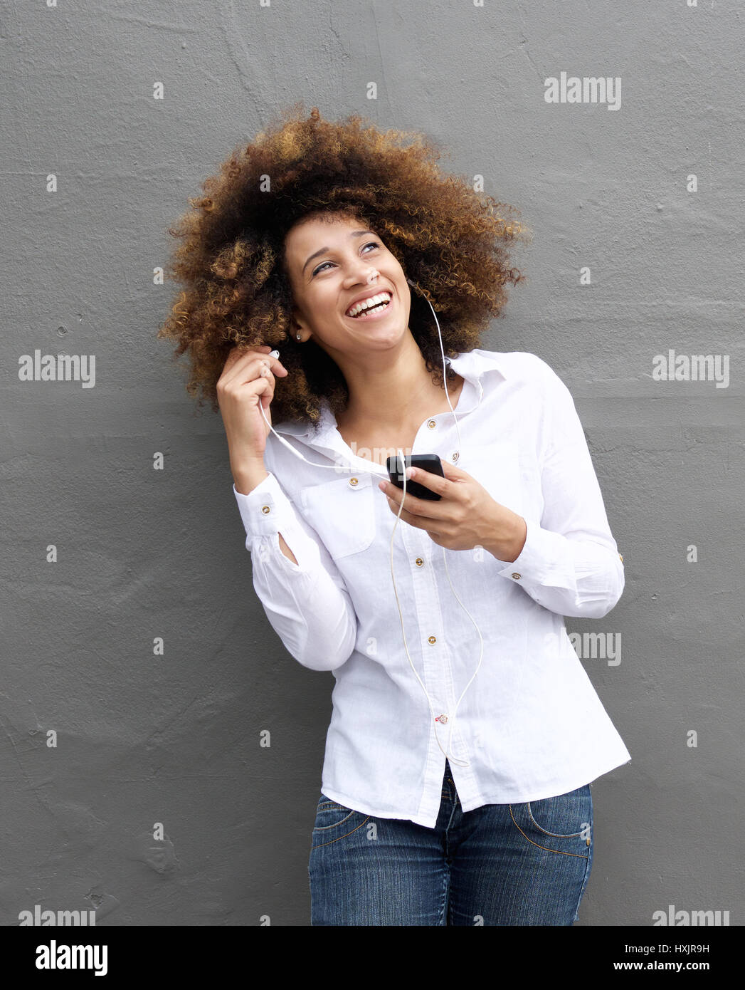 Portrait of cheerful young african american woman laughing with ...