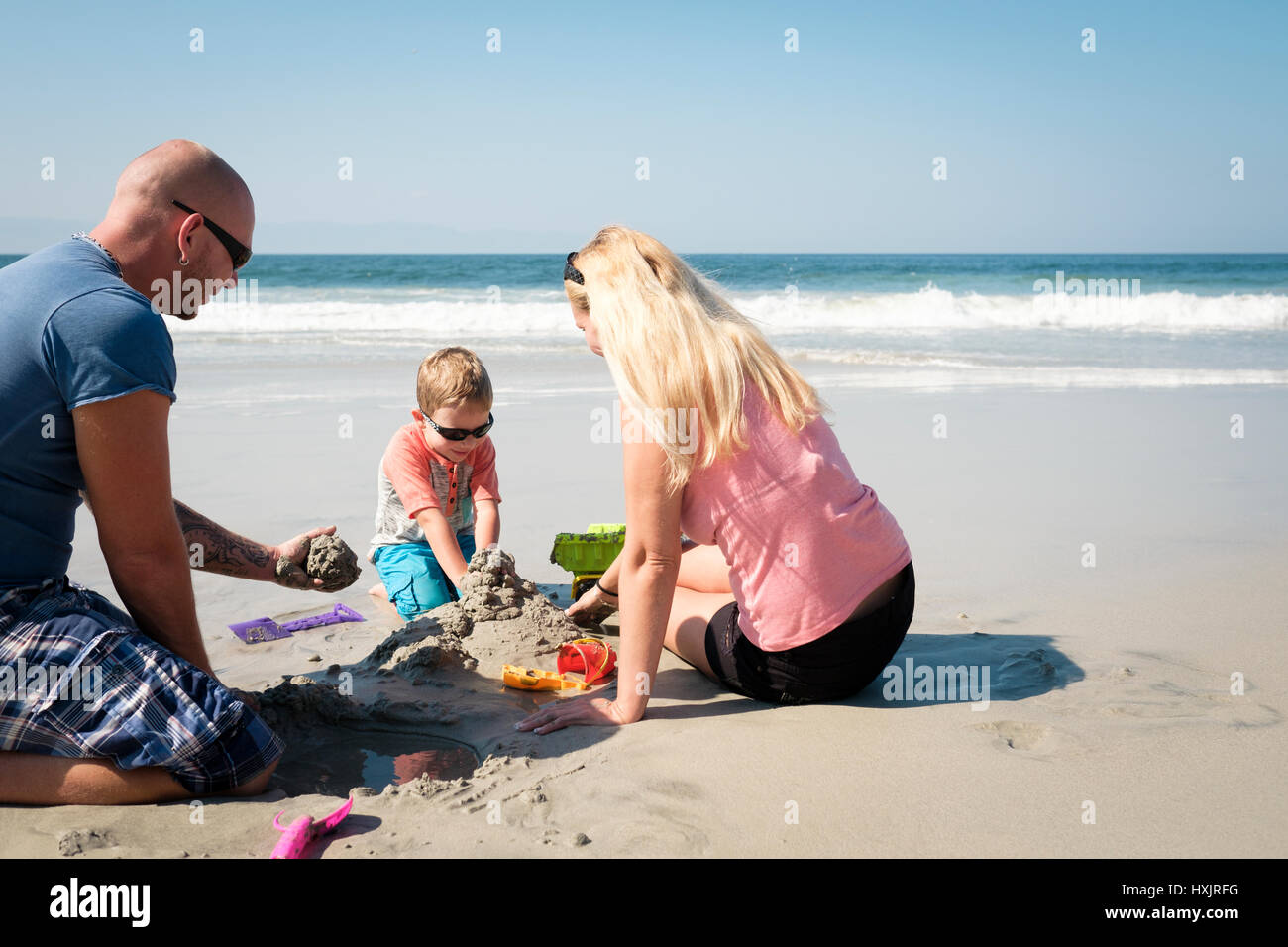 Family playing in the sand on the beach in Riviera Nayarit Mexico