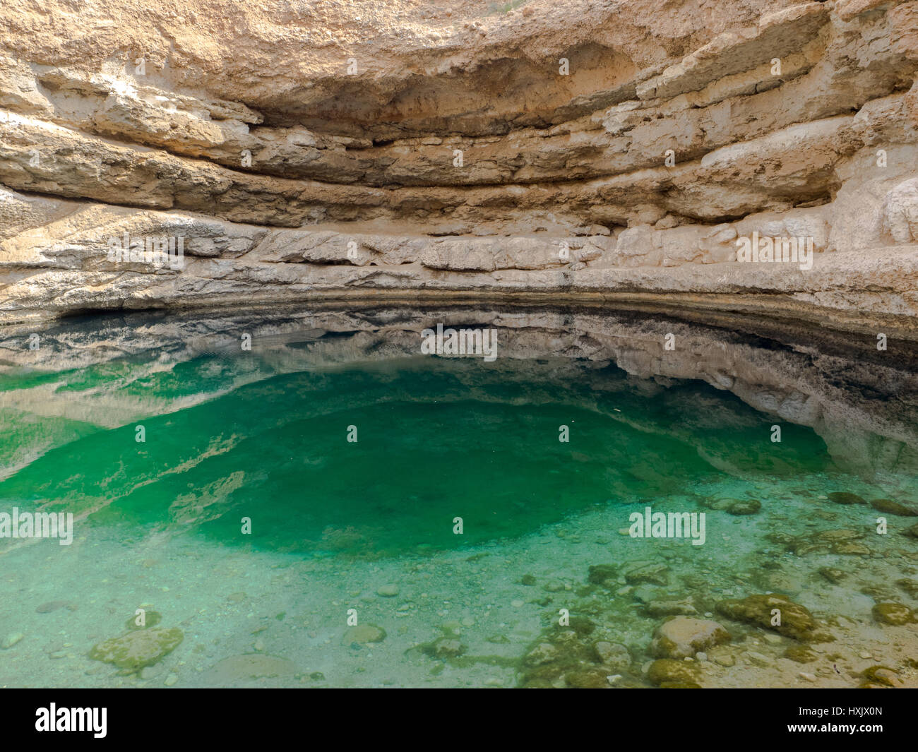 Bimmah sink hole, a water-filled depression in the limestone of eastern Muscat Governorate in the Sultanate of Oman. Stock Photo