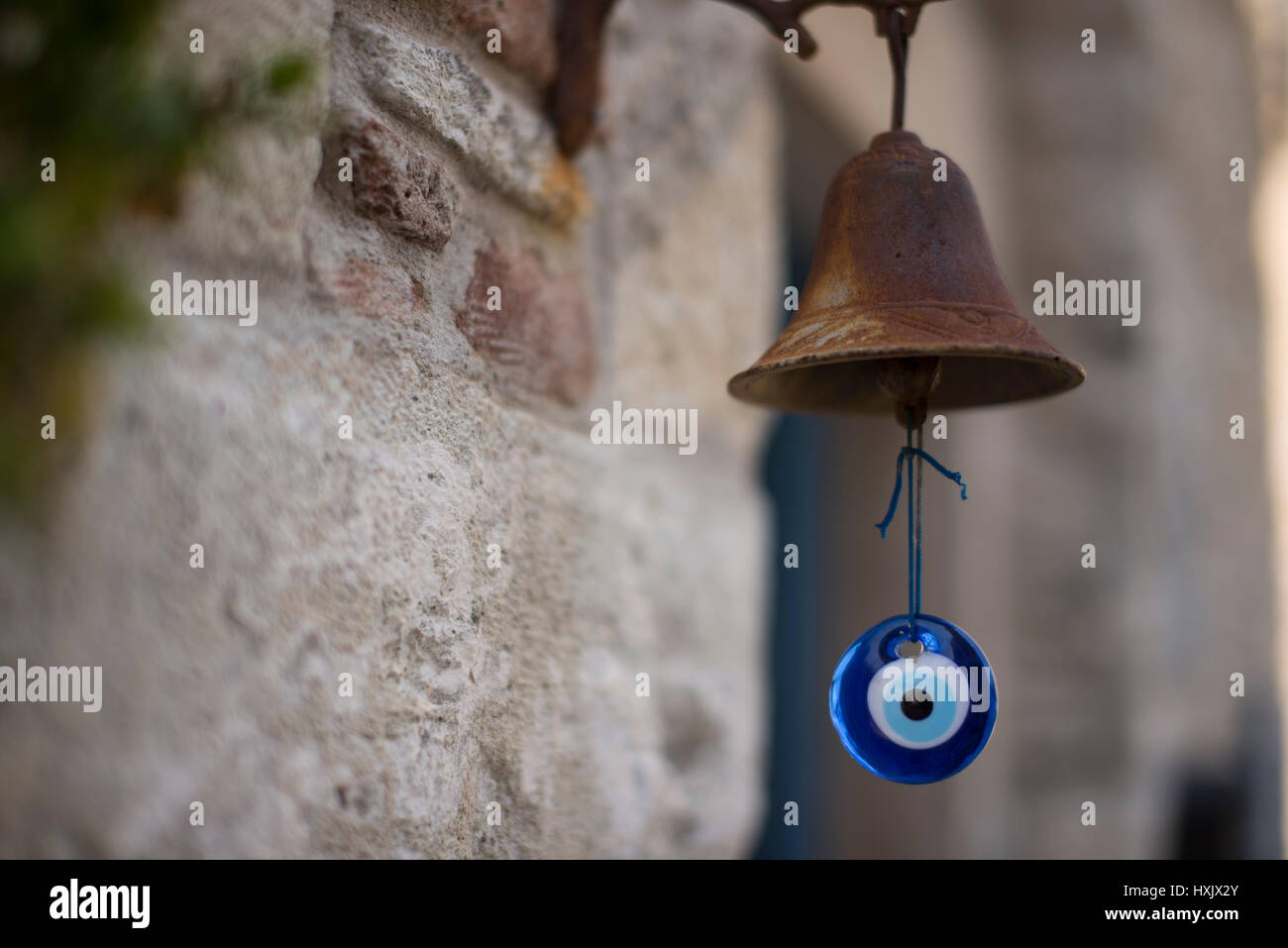 Rusted metal bell and amulet doorbell. Stock Photo