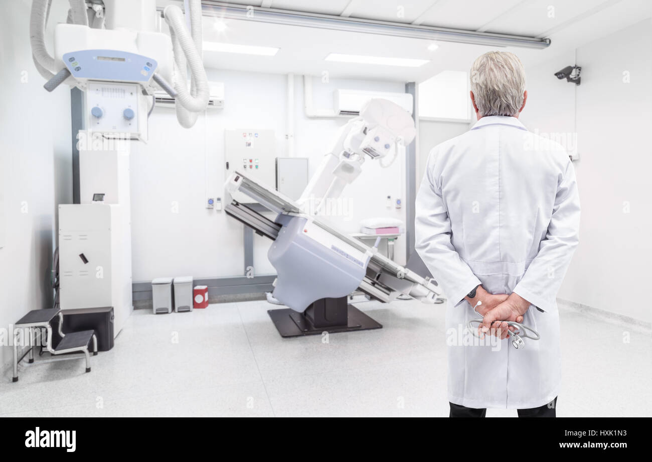 Senior doctor looking at CT (Computed tomography) scanner in hospital laboratory Stock Photo