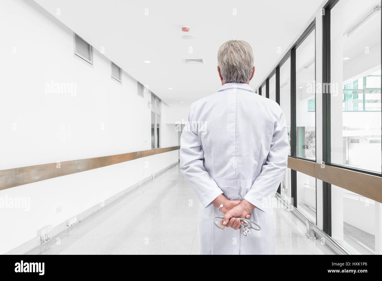 Rear view senior doctor looking at the hospital hallway Stock Photo - Alamy