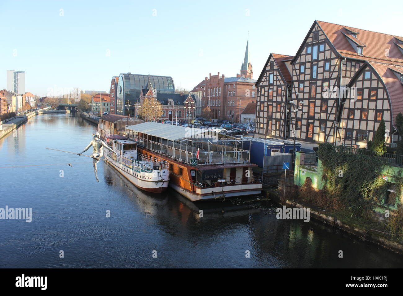 View of the Brda river with sculpture of tightrope walker, in the city of Bydgoszcz, Northern Poland Stock Photo