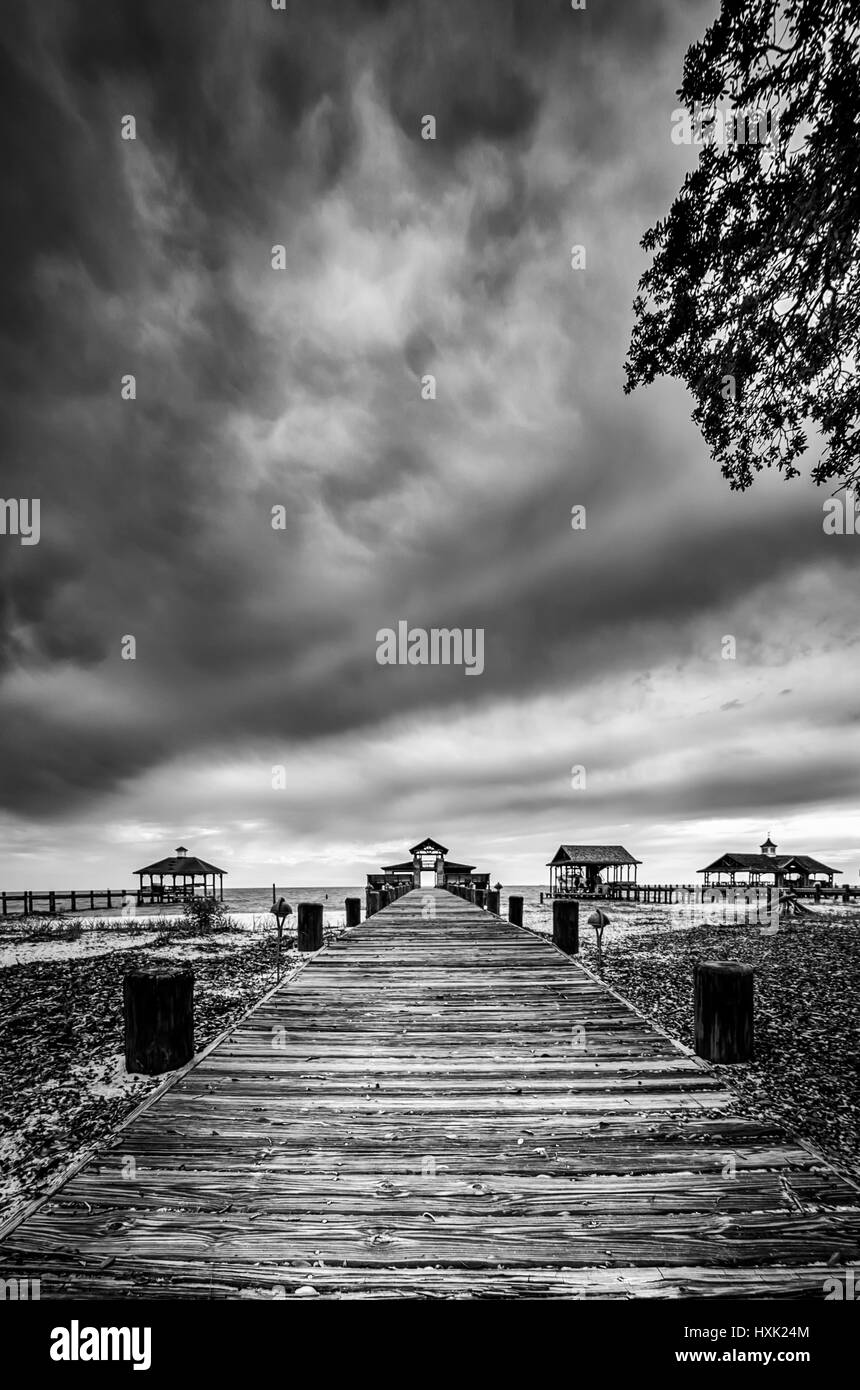 Point Clear AL USA - May 2, 2014  -  Wooden walkway across the sand to a boat dock Stock Photo