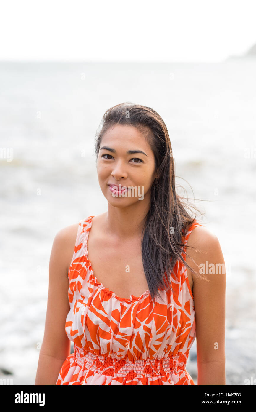 Lifestyle portrait of an attractive Hawaiian woman wearing a flower ...