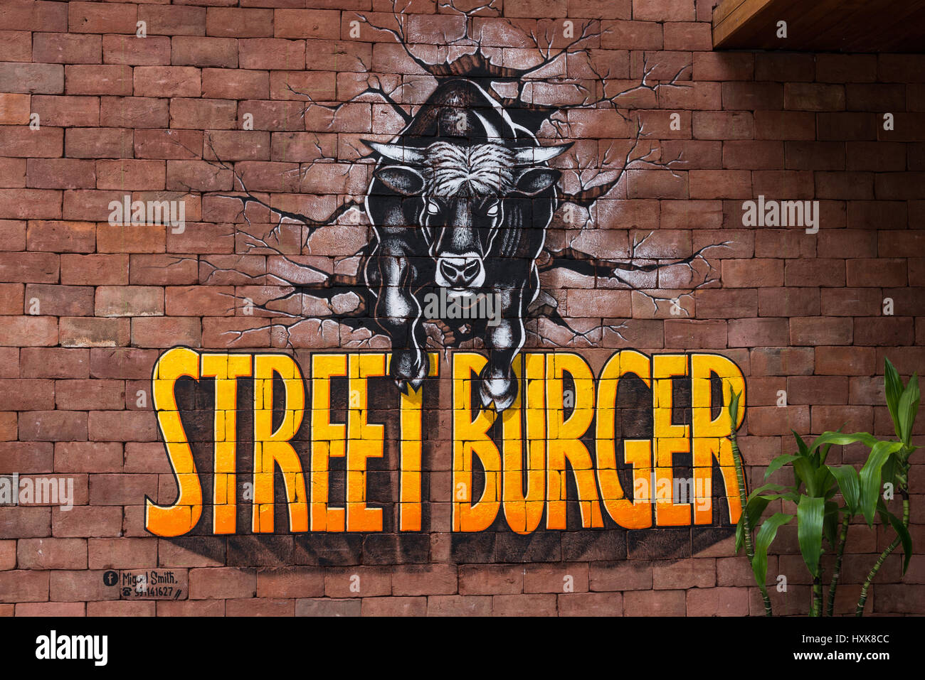 A painted sign on brick wall for the Street Burger restaurant. Lima, Peru. Stock Photo