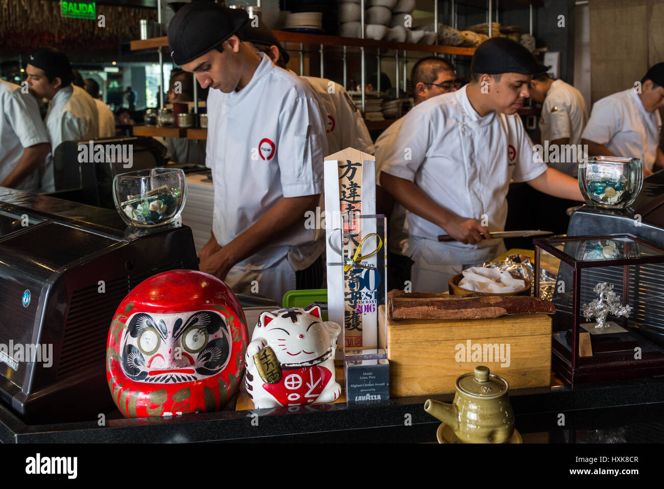Chefs are busy behind Sushi bar at the Maido Restaurant. Lima, Peru. Stock Photo