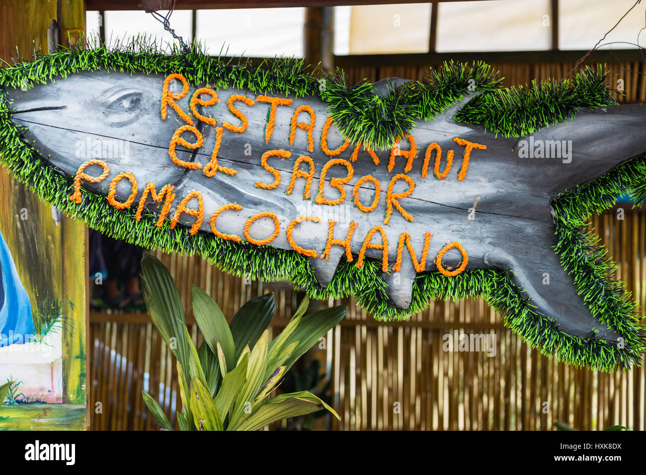 A colorful fish shaped sign in front of a restaurant. Northern Peru. Stock Photo