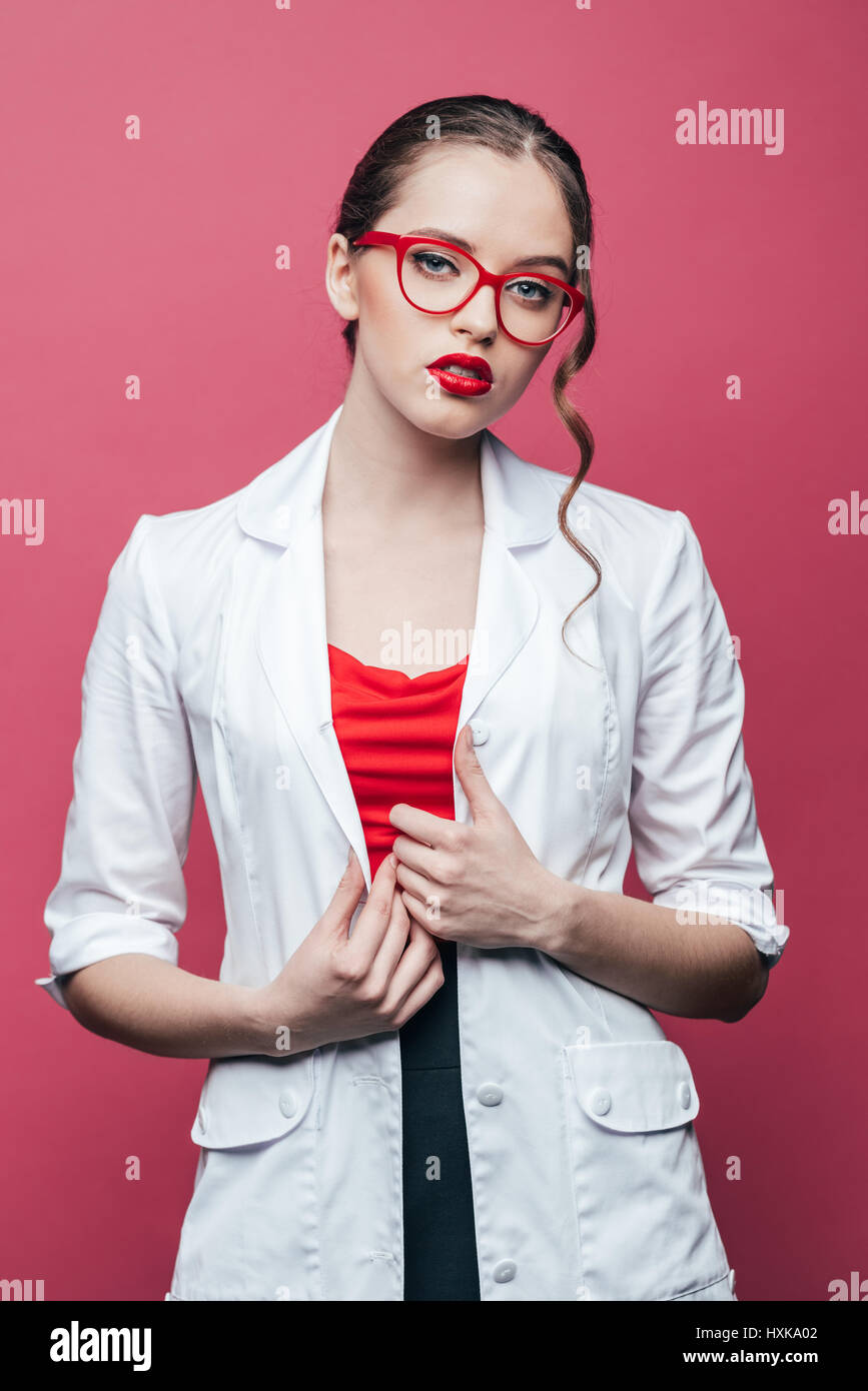 portrait of confident professional doctor in white coat and glasses on ...