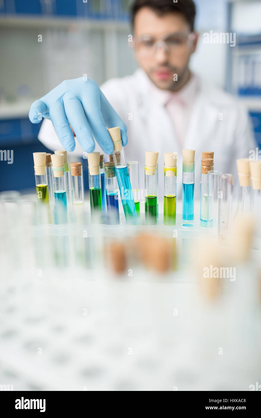 man scientist working with glass tubes in lab Stock Photo