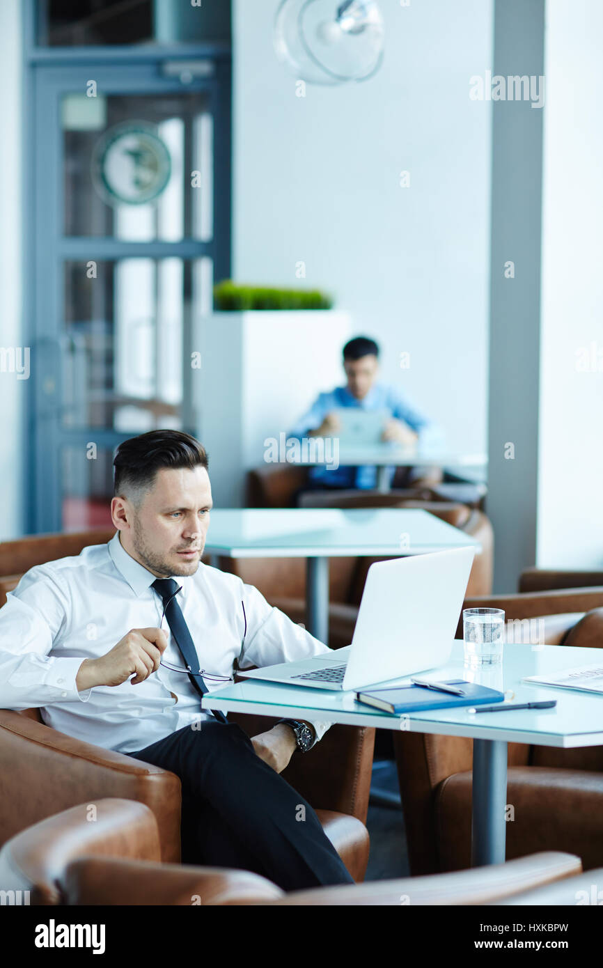 Businesspeople Working in Cyber Cafe Stock Photo