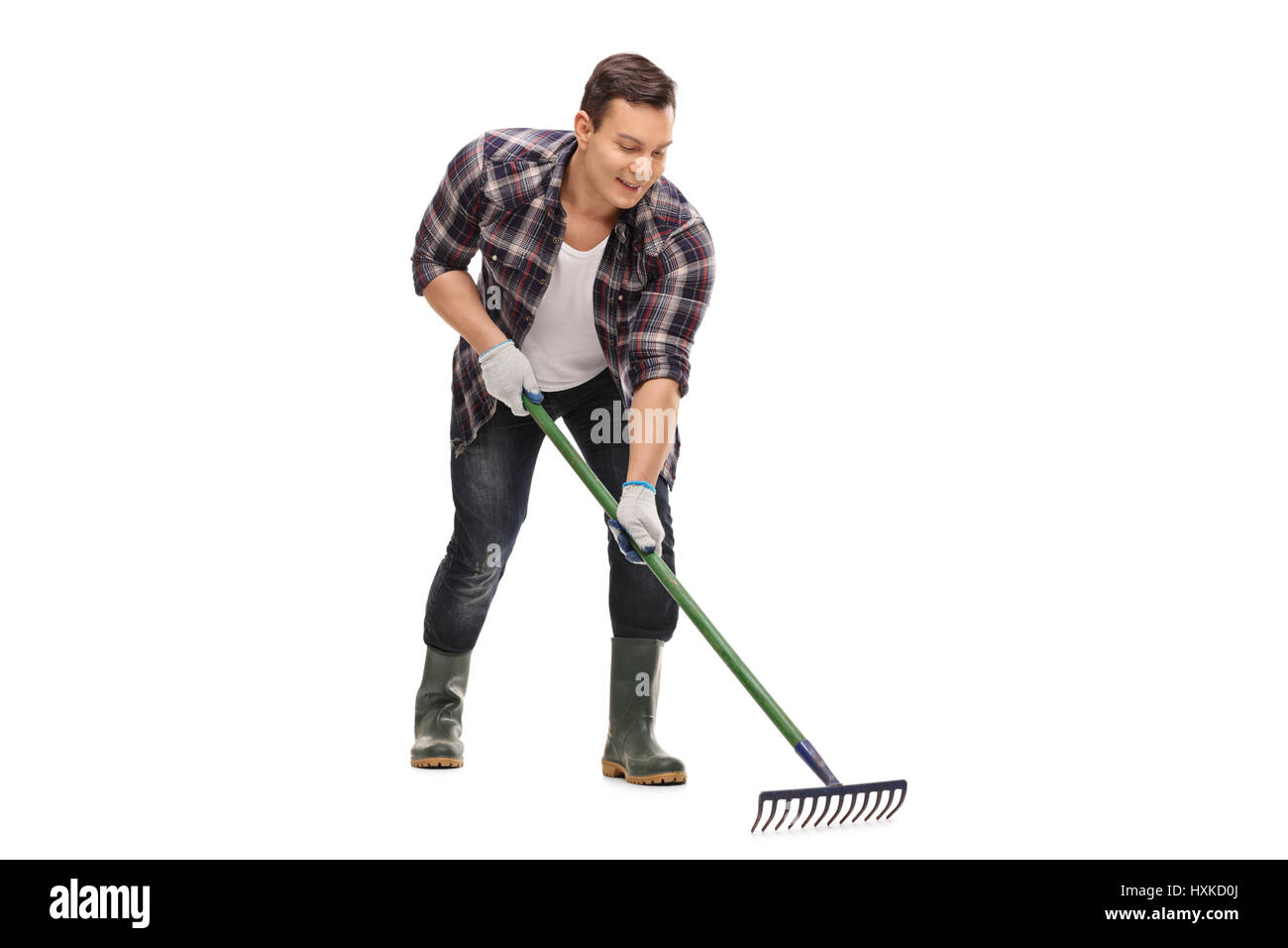 Young gardener using a rake isolated on white background Stock Photo