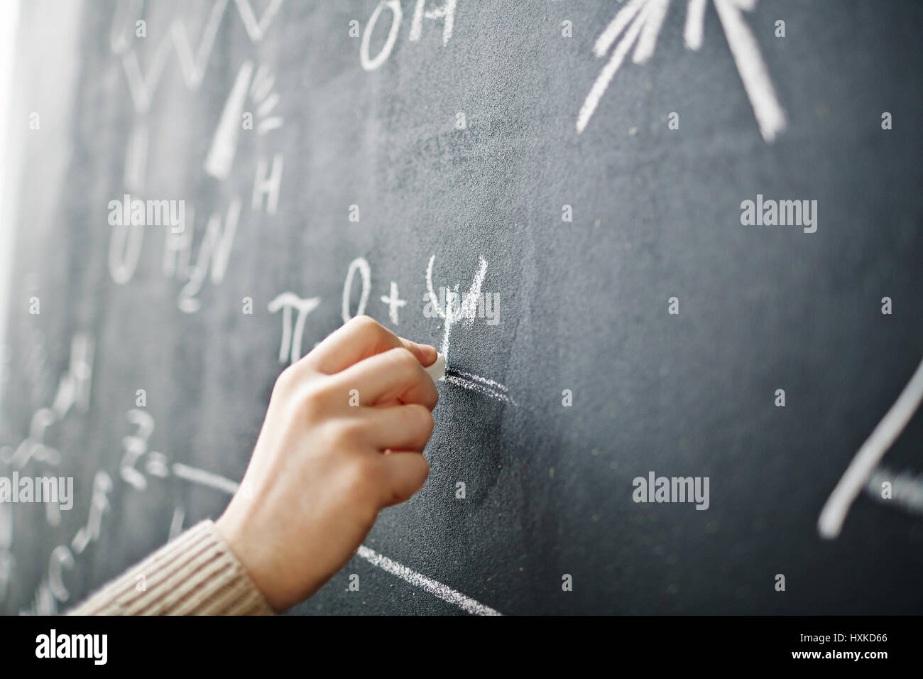 Hand Writing Formula on Blackboard Stock Photo
