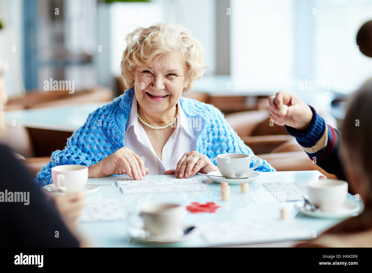 Playing lotto with senior friends Stock Photo