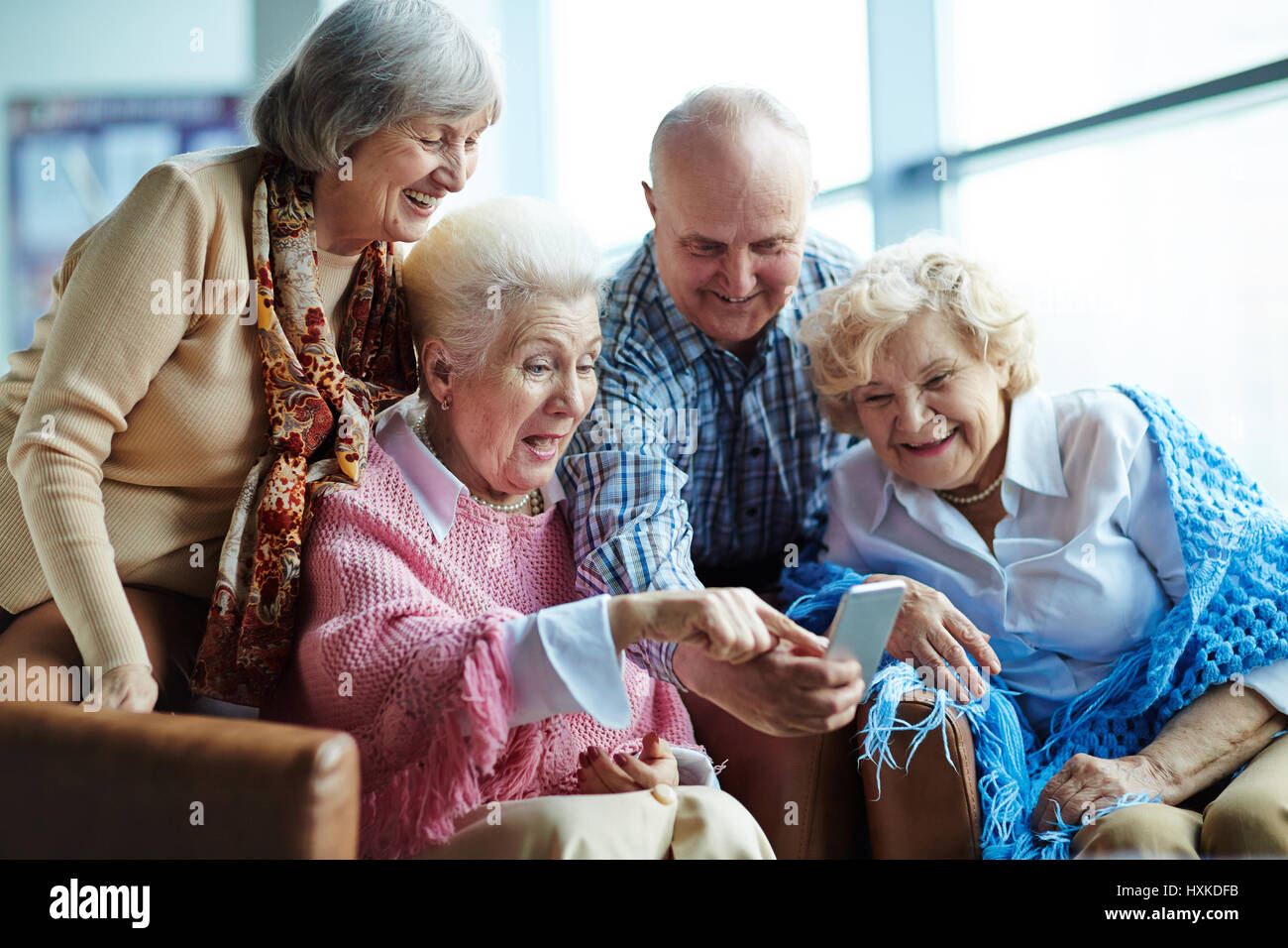 Tech-savvy seniors with smartphone Stock Photo