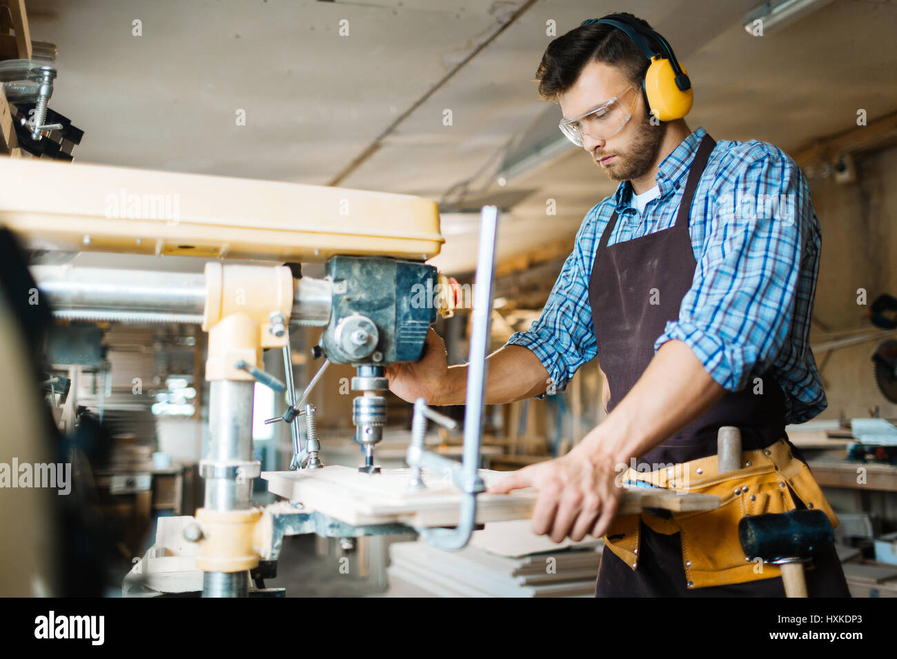 Using drill press in workshop Stock Photo