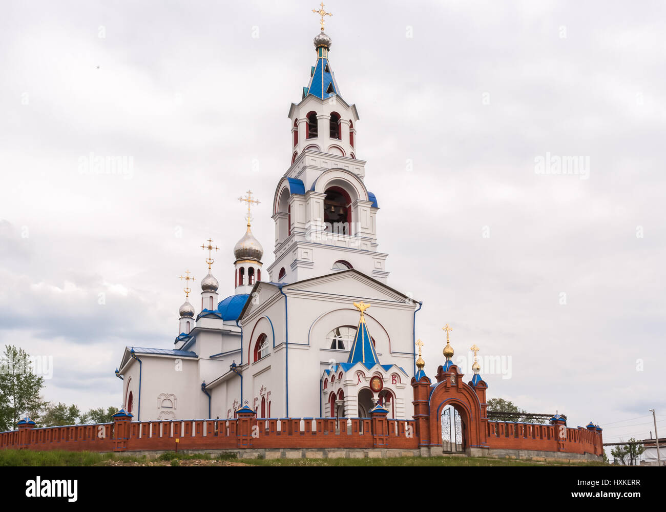 Orthodox temple. Church of the Dormition at cloudy summer day. Novoutkinsk, Russia. Stock Photo