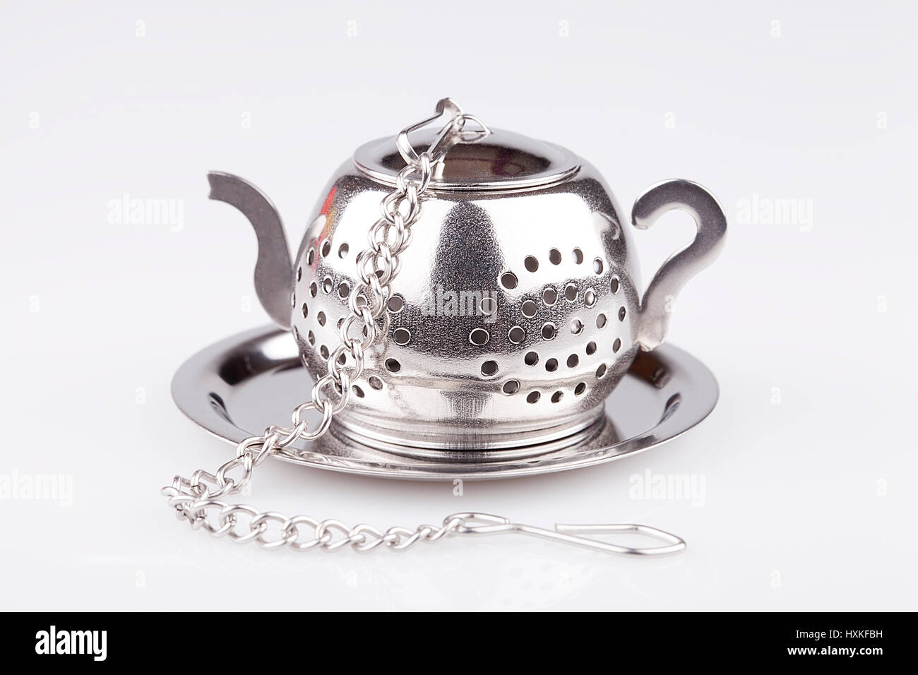 Metal teapot loose leaves tea strainer isolated on white background
