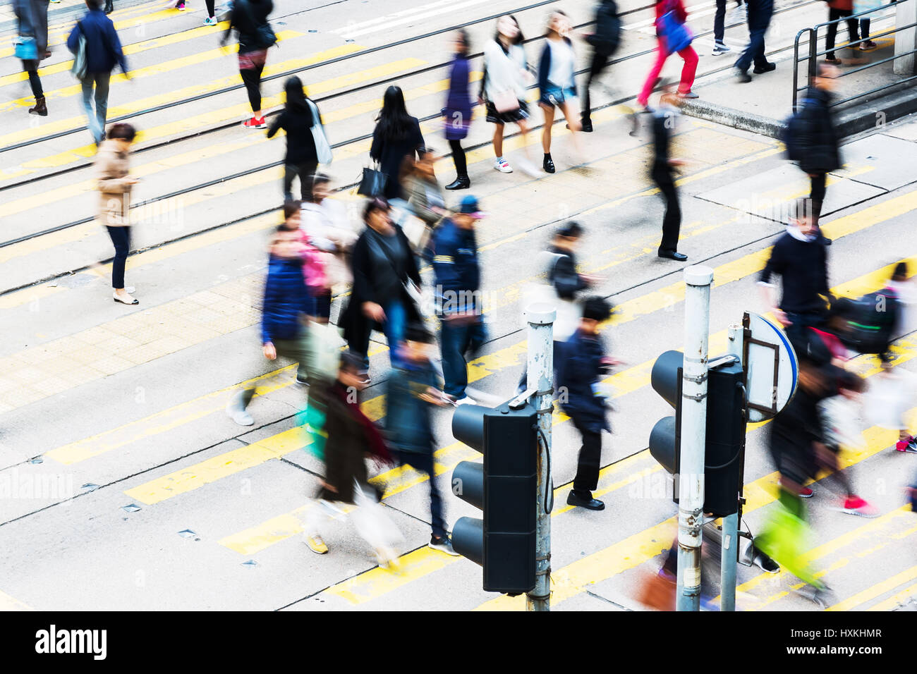 picture made with motion blur of people crossing a street in Hongkong ...