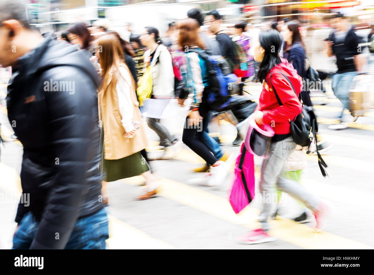 picture made with motion blur of people crossing a street in Hongkong ...