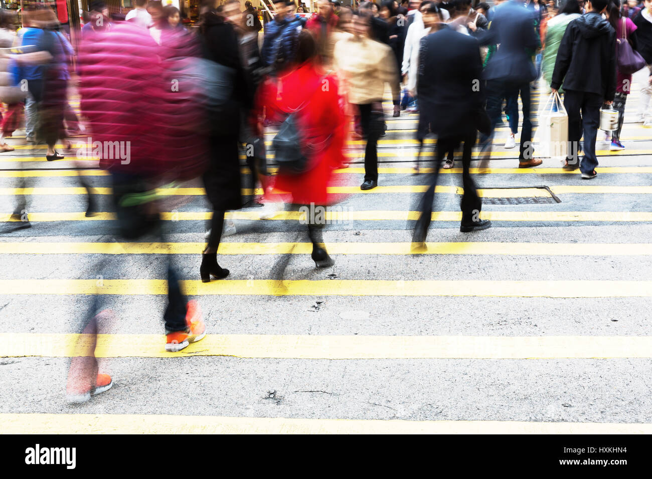 picture made with motion blur of people crossing a street in Hongkong ...