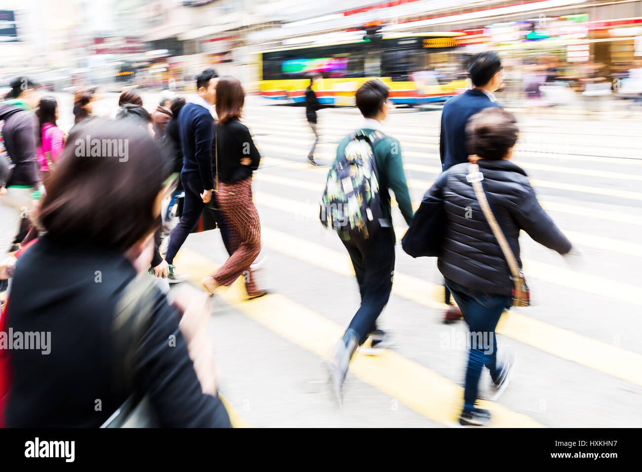picture made with motion blur of people crossing a street in Hongkong ...