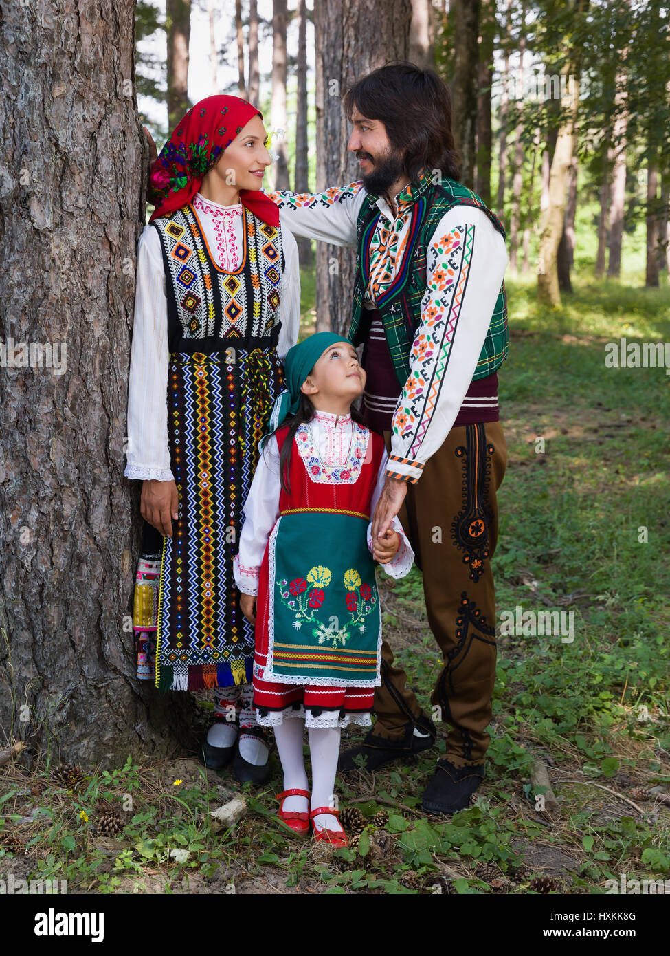 Young family posing in traditional Bulgarian costume during a folklore festival Stock Photo