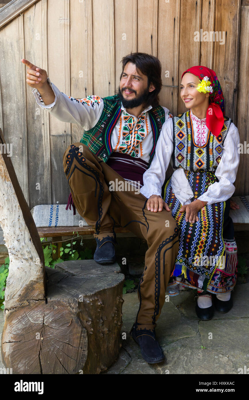 Young happy couple sitting in traditional Bulgarian costume Stock Photo