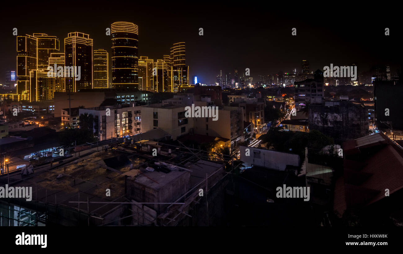 High Sky bar view of the contrasts of night time cityscape of Metro Manila, Philippines. Stock Photo