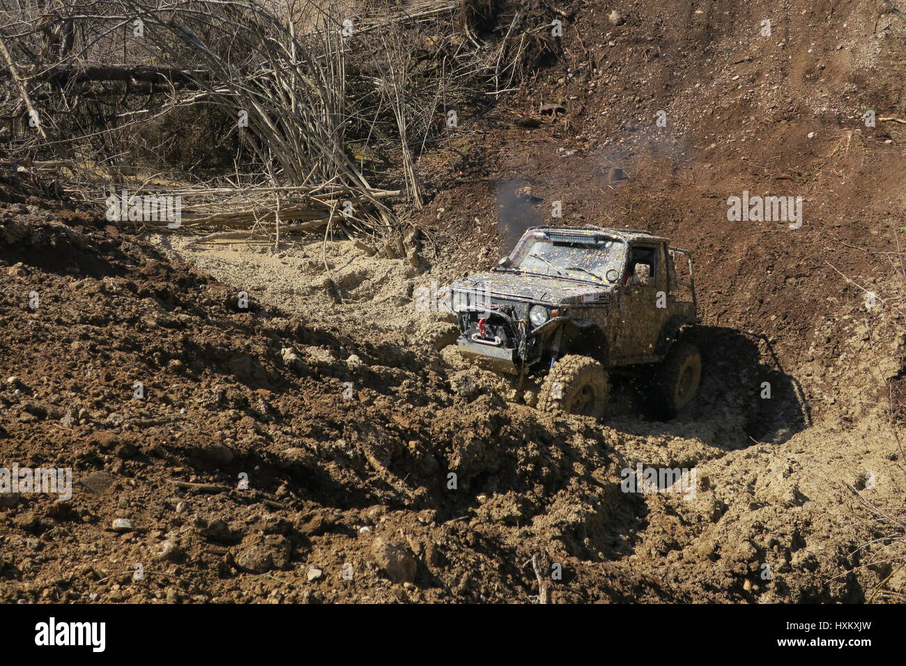 The fourwheel drive is getting stuck in a muddy trench at offroad race
