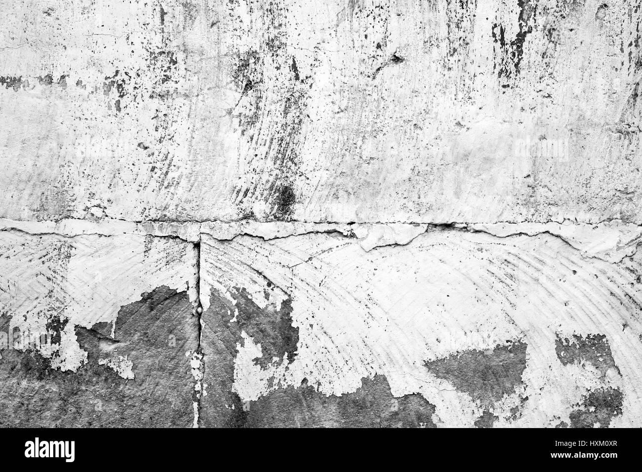 Old concrete wall with peeling white paint layer, background photo texture Stock Photo