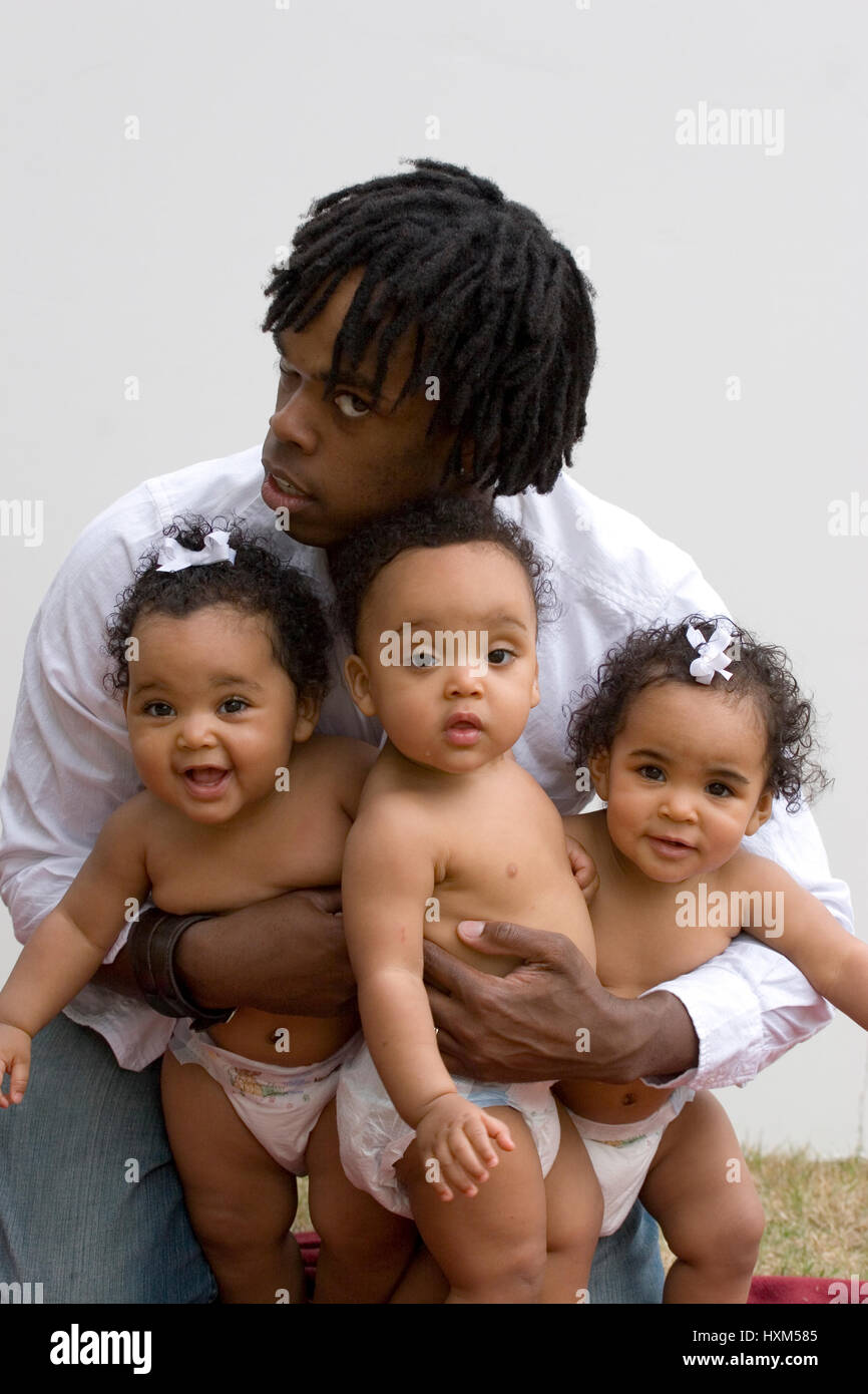 Stessed dad with his hands full isolated on white. Stock Photo