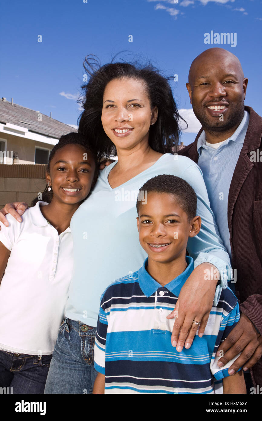 Happy African American family standing outside smiling Stock Photo - Alamy