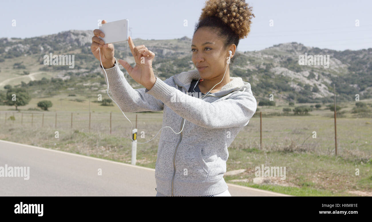 Young woman taking picture of nature Stock Photo - Alamy