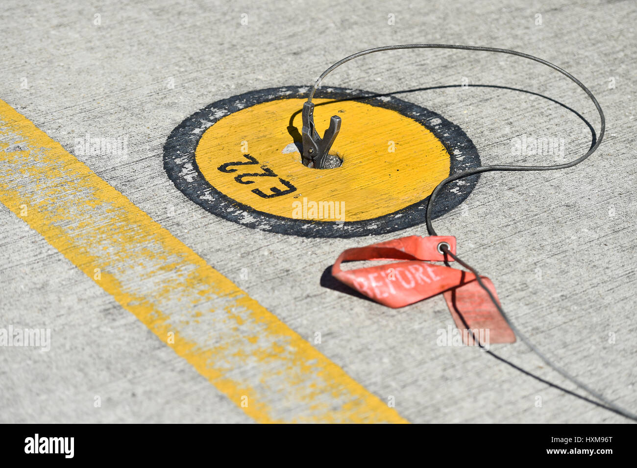 Static grounding clamps connected on an airplane on the runway Stock