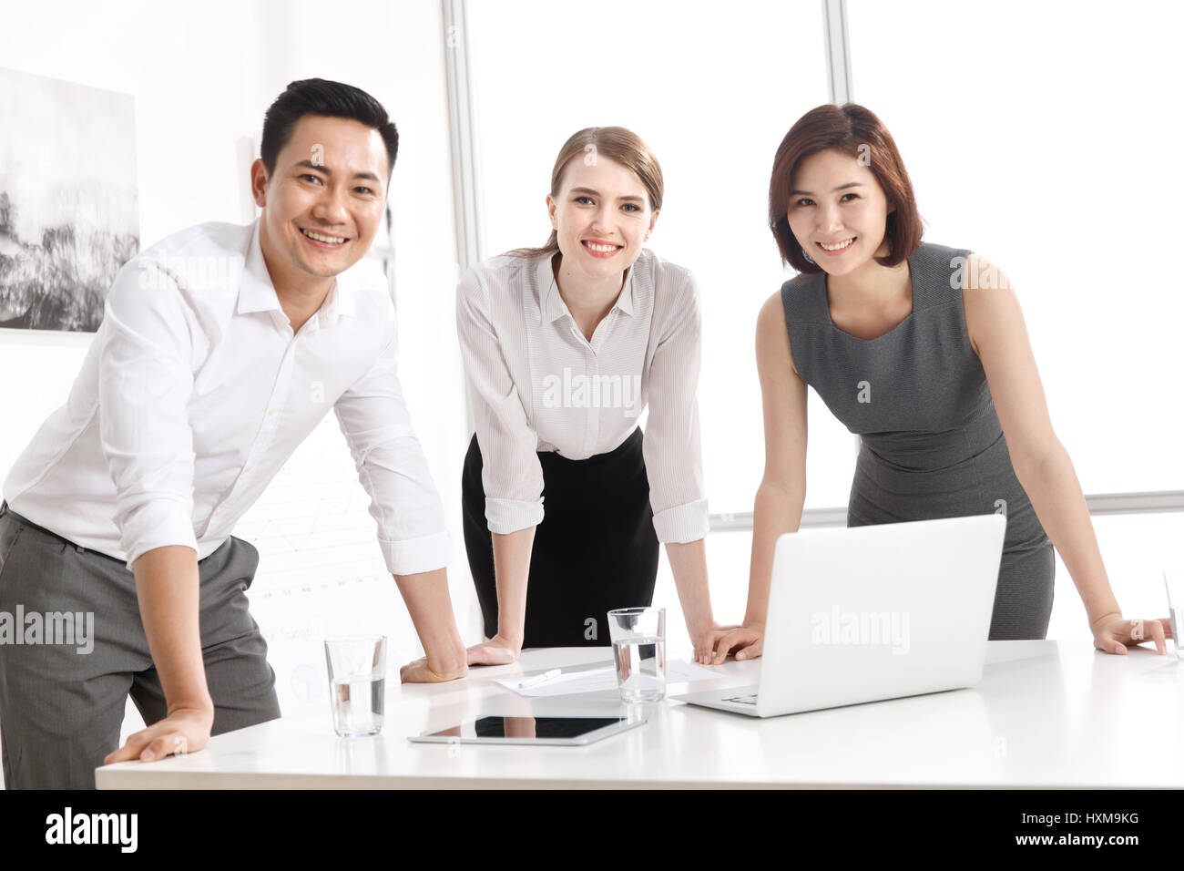 Three business people in office Stock Photo - Alamy