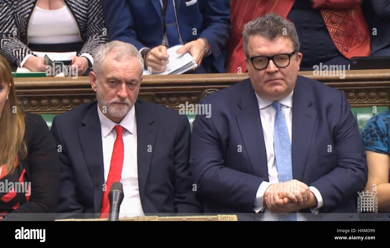 Labour Party leader Jeremy Corbyn (left) and deputy leader Tom Watson listen to a response by Prime Minister Theresa May in the House of Commons, London, after triggered Article 50, starting a two-year countdown to the UK leaving the EU. Stock Photo