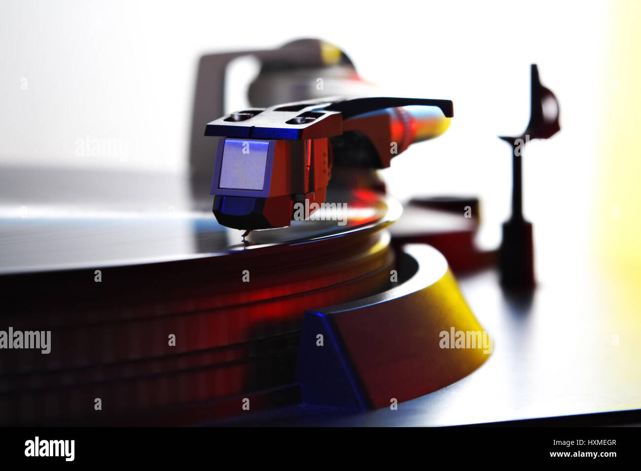 turntable needle on spinning record, colored light Stock Photo Alamy