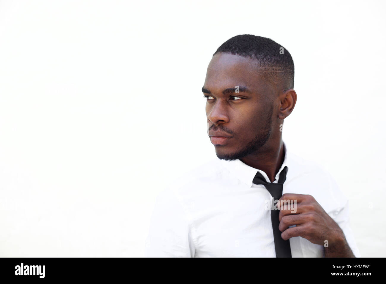 Close up portrait of smart young african businessman looking away on ...