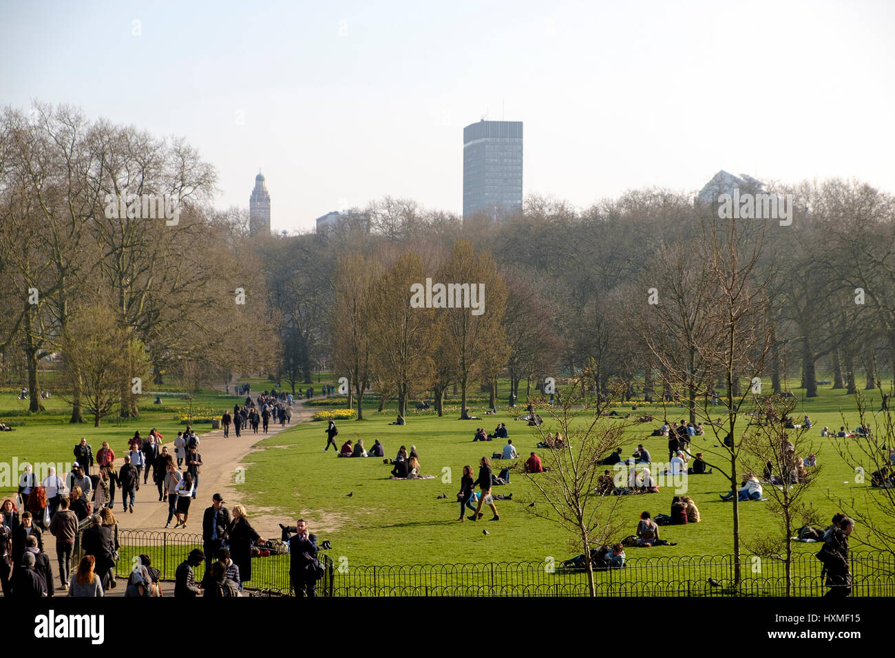 On a warm, sunny day in March, people are out in Green Park London