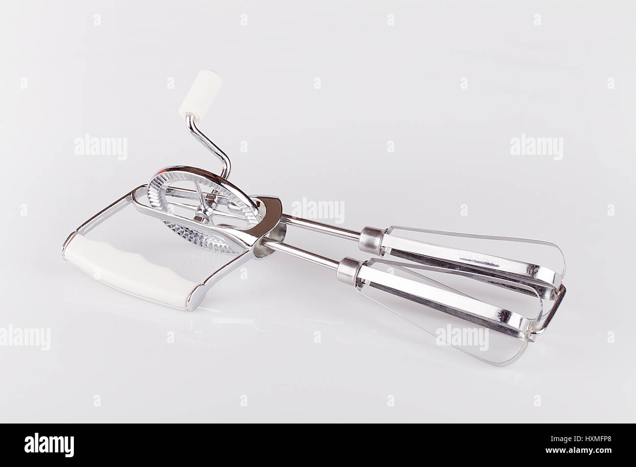Hand mixer on a white surface. Manual egg beater isolated on white  background Stock Photo - Alamy