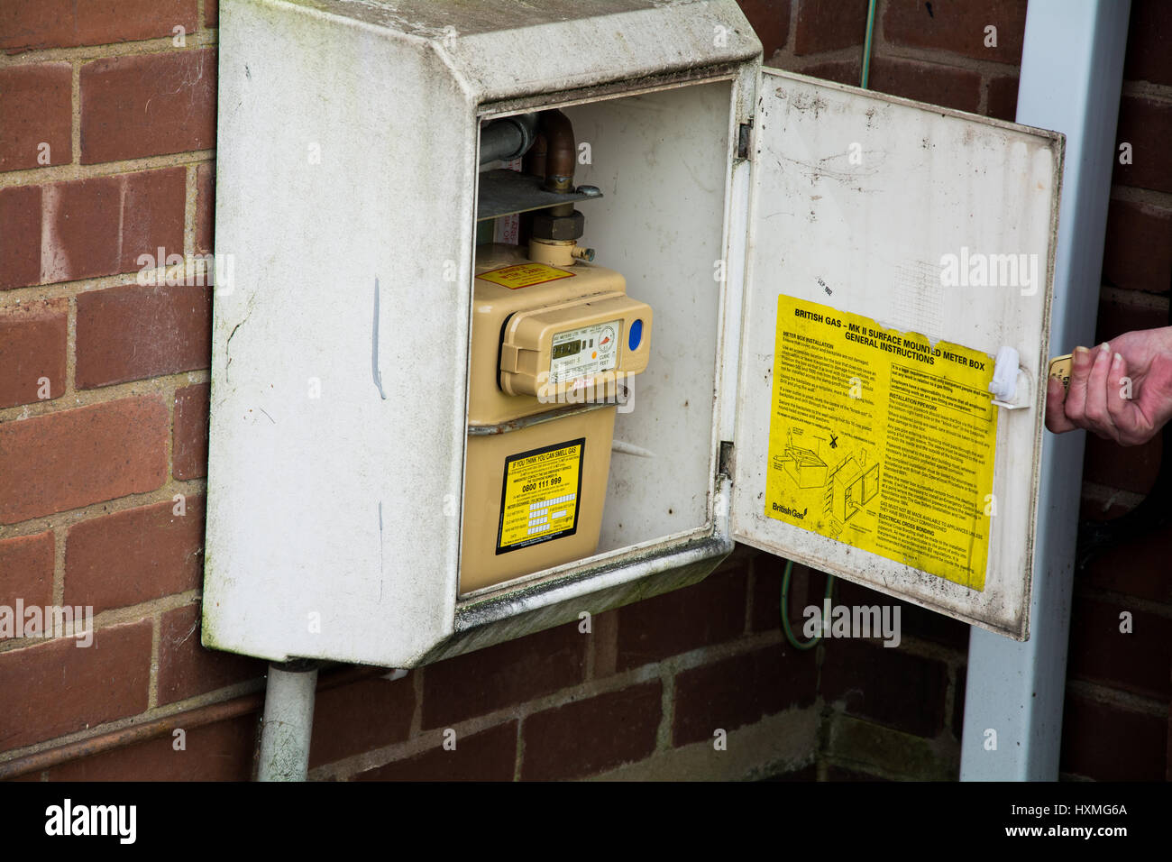 Taking a gas meter reading in the UK. Stock Photo